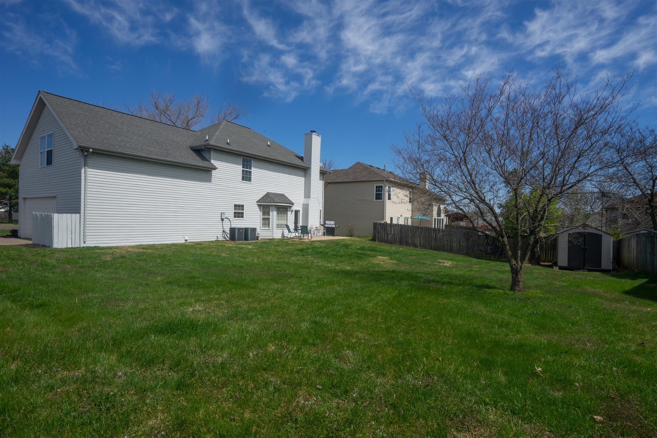 4002 Amber Way Spring Hill, TN 37174 - Photo 20 of 21 a view of a white house in front of a big yard with large trees