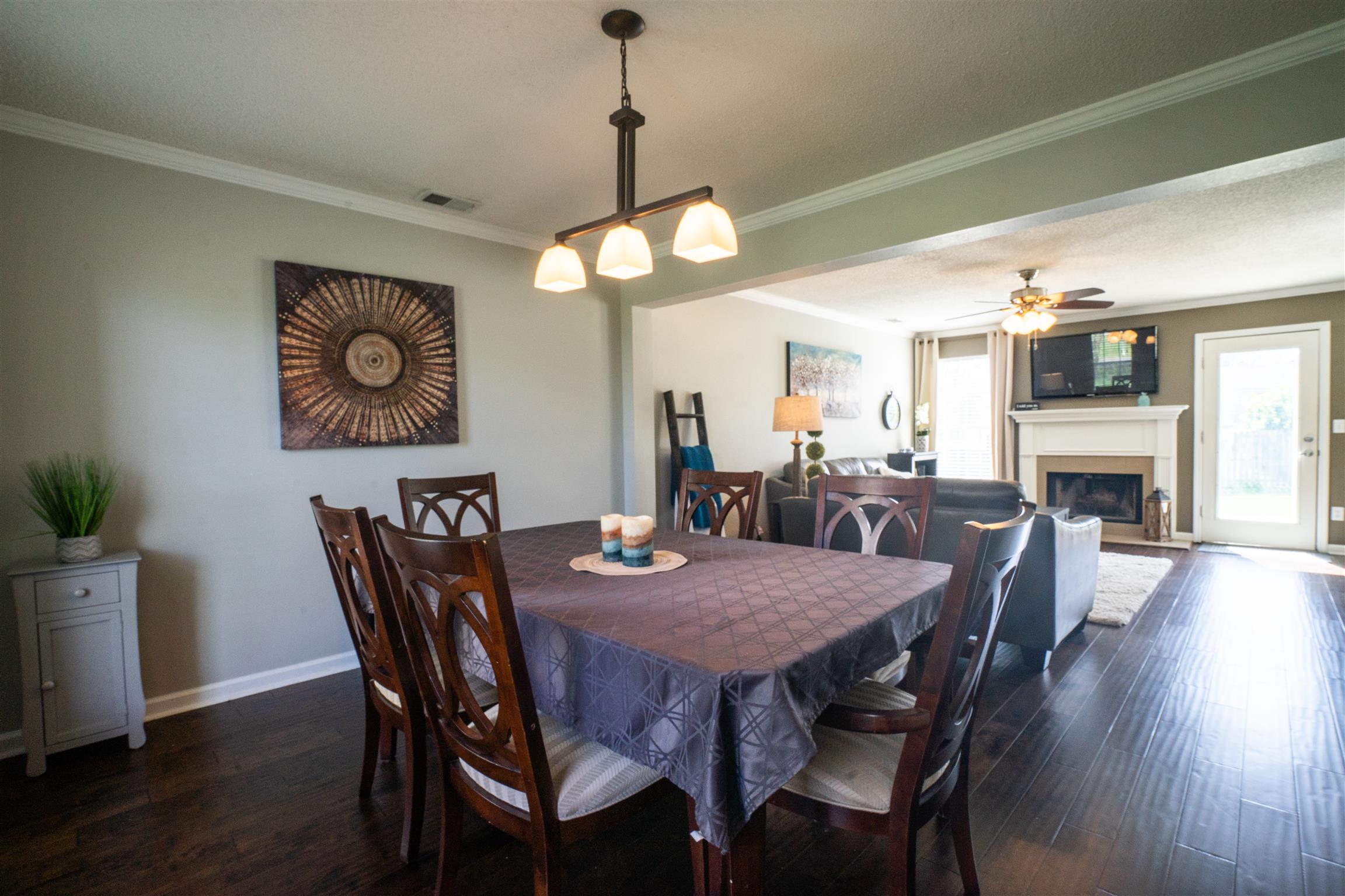 4002 Amber Way Spring Hill, TN 37174 - Photo 4 of 21 a view of a dining room with furniture wooden floor and a chandelier