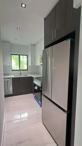 a kitchen with a refrigerator and a sink