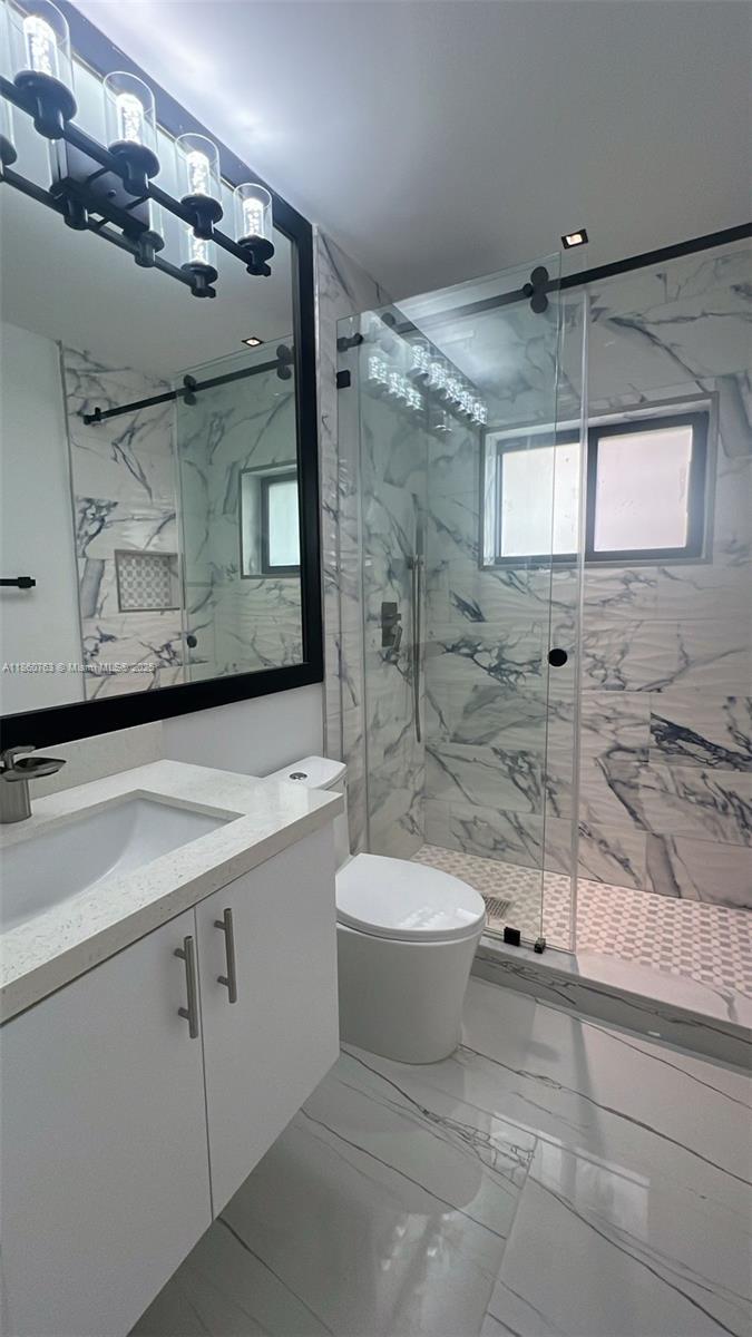 1155 102nd Street, Unit 7 Bay Harbor Islands, FL 33154 - Photo 7 of 10 a bathroom with a sink toilet and shower