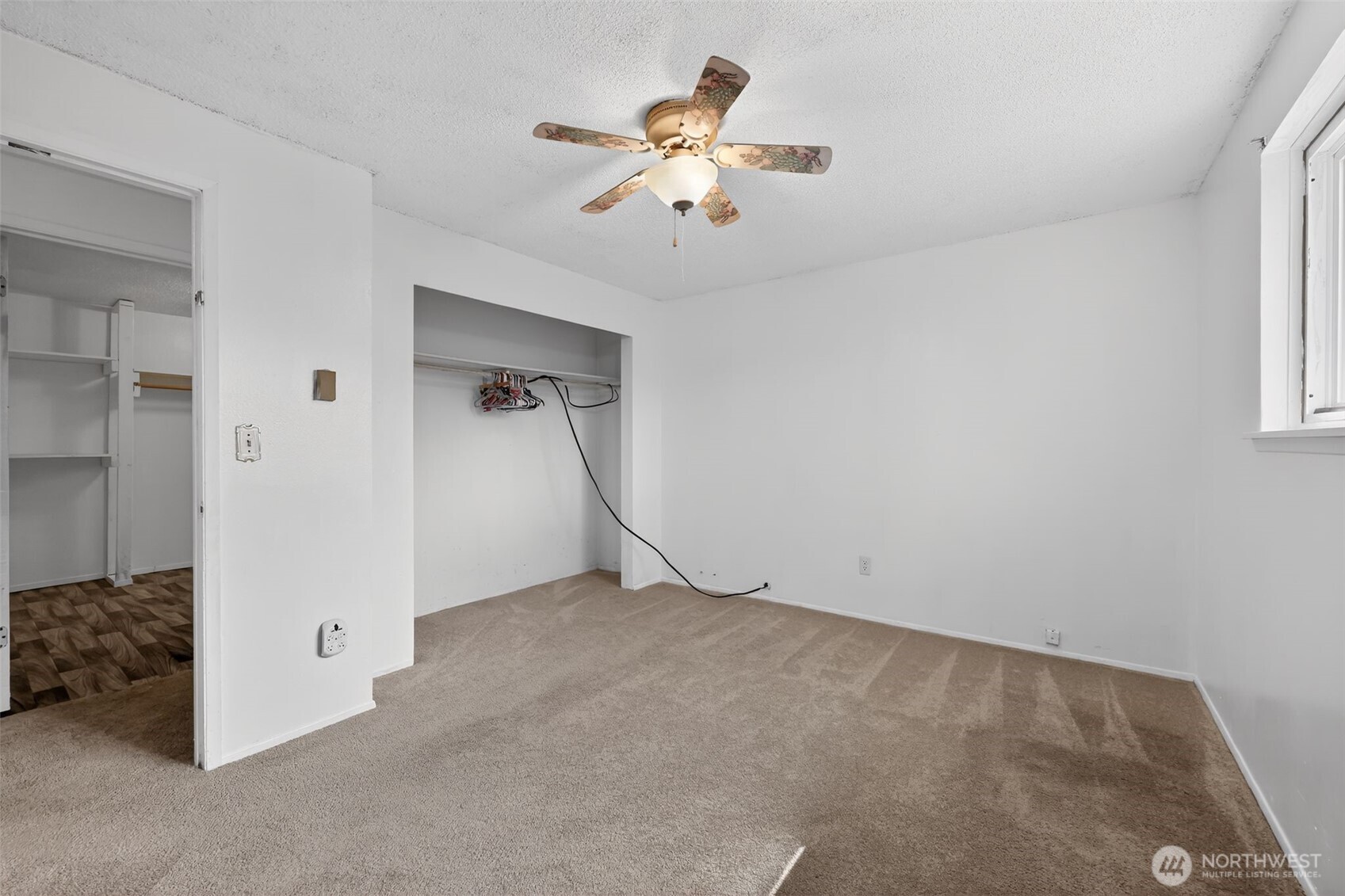 1010 Coolidge Road Aberdeen, WA 98520 - Photo 12 of 22 an empty room with chandelier fan and windows