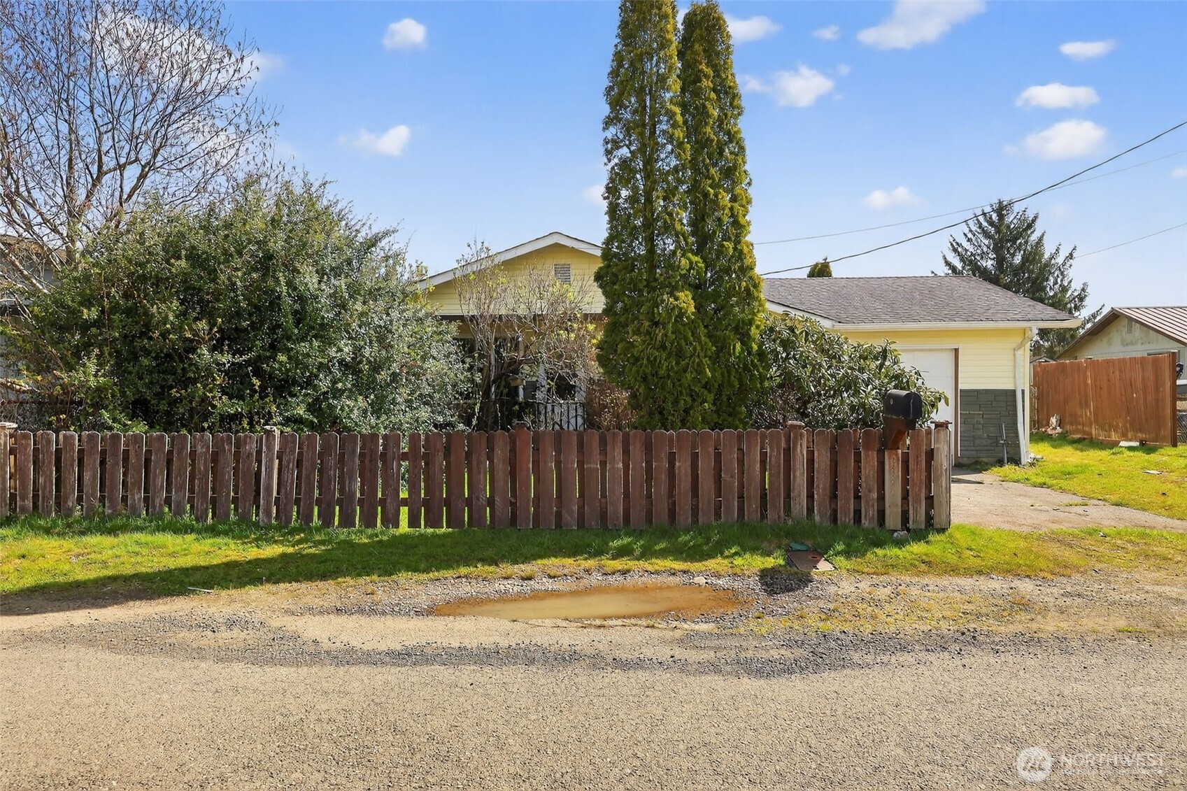 1010 Coolidge Road Aberdeen, WA 98520 - Photo 22 of 22 a view of a backyard with a house and wooden fence