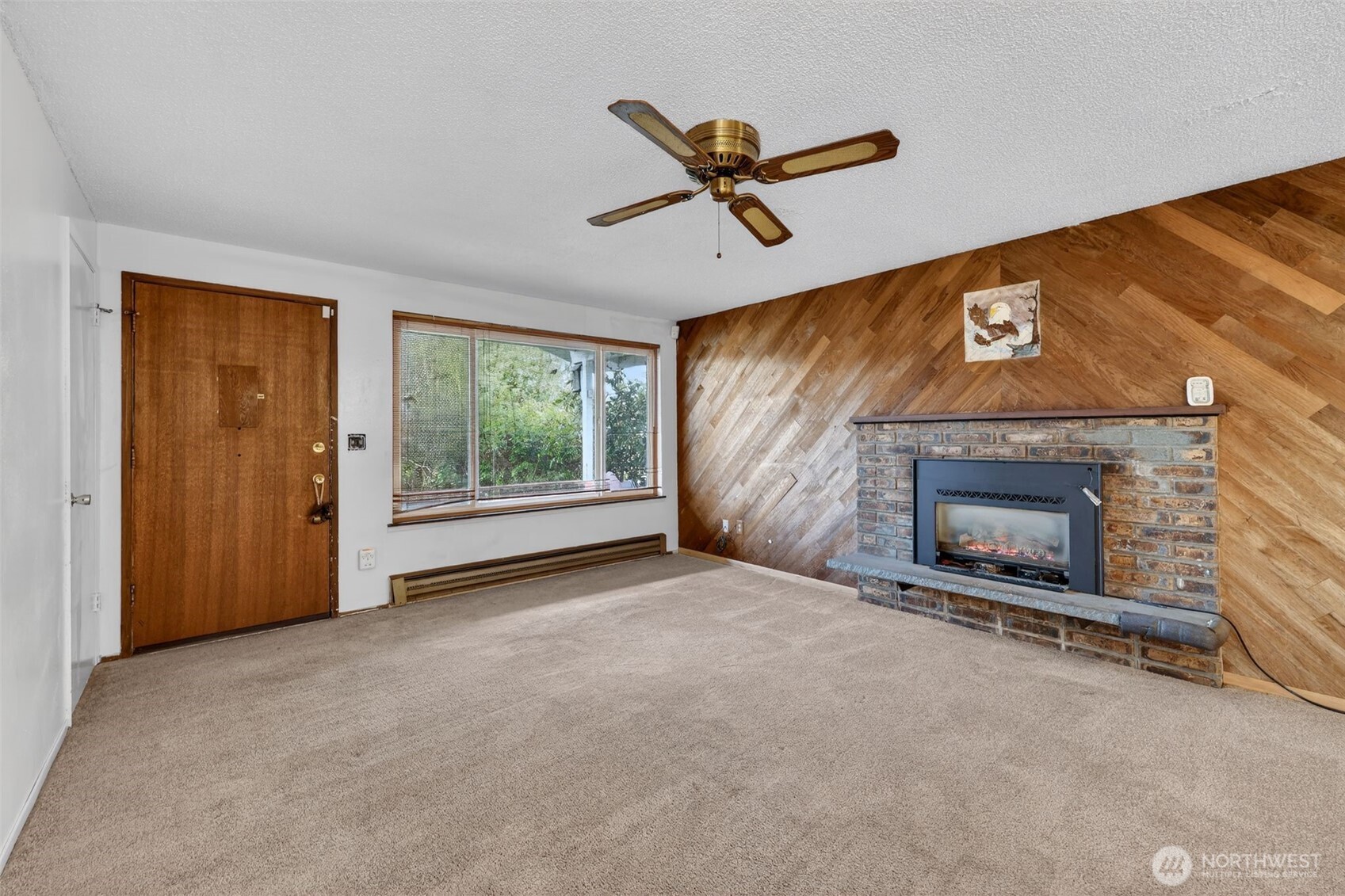 1010 Coolidge Road Aberdeen, WA 98520 - Photo 5 of 22 a view of an empty room with a fireplace and a window