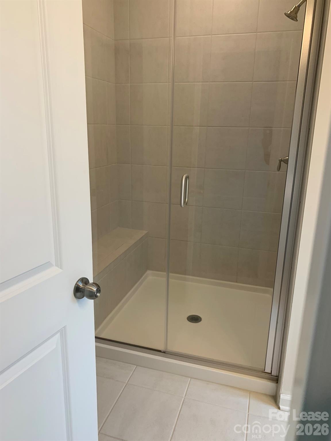 2143 Stevens Mill Road Matthews, NC 28104 - Photo 23 of 39 a bathroom with a glass shower door
