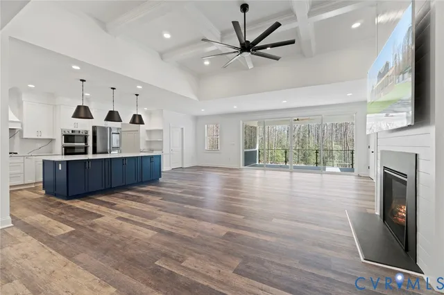 a view of an empty room with a fireplace and a window