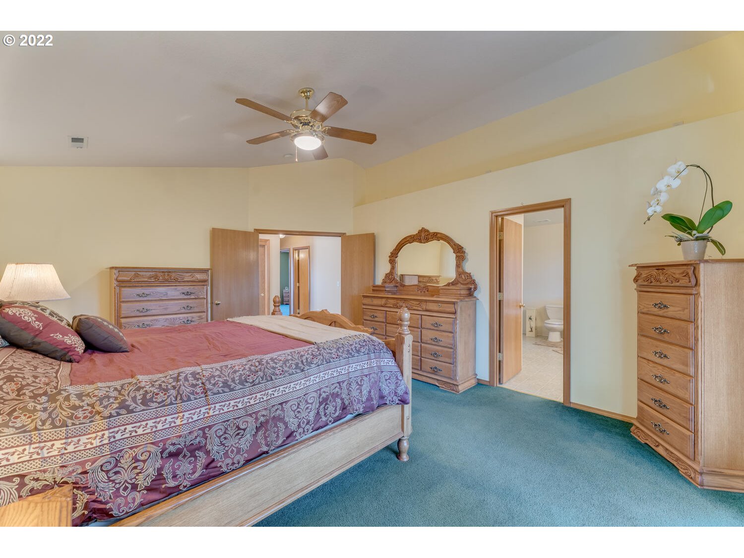1012 57th Street Washougal, WA 98671 - Photo 19 of 31 a bedroom with a large bed and a chandelier
