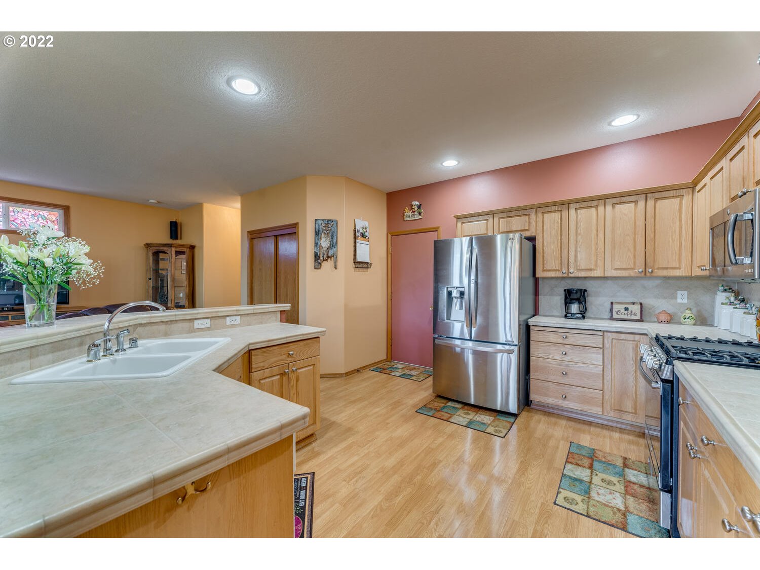 1012 57th Street Washougal, WA 98671 - Photo 7 of 31 a kitchen with stainless steel appliances granite countertop a sink stove and refrigerator