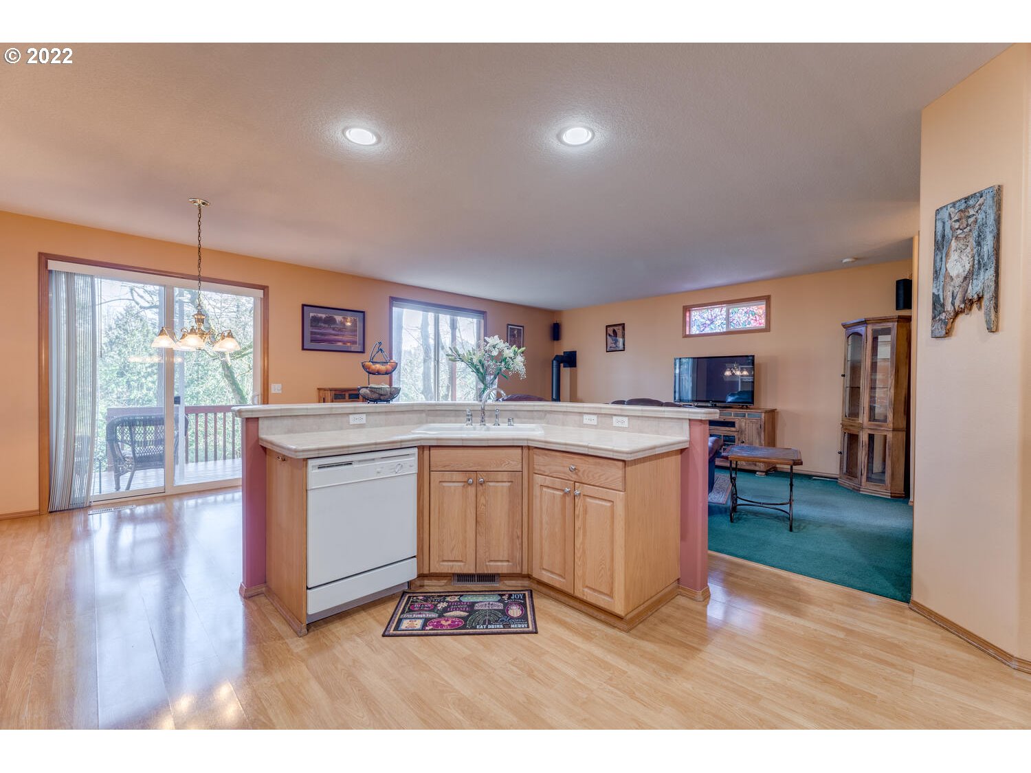 1012 57th Street Washougal, WA 98671 - Photo 8 of 31 a kitchen with granite countertop a stove top oven a sink a dining table and chairs
