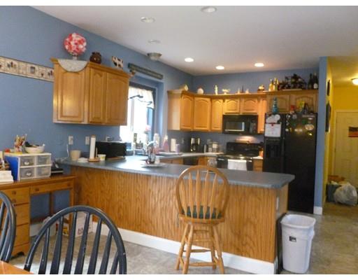 25 Lafayette Road Templeton, MA 01468 - Photo 4 of 13 a kitchen with granite countertop a refrigerator a stove a sink dishwasher with a dining table and chair