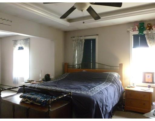 25 Lafayette Road Templeton, MA 01468 - Photo 8 of 13 a bedroom with a bed and a chandelier