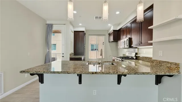 a kitchen with counter top space cabinets and stainless steel appliances