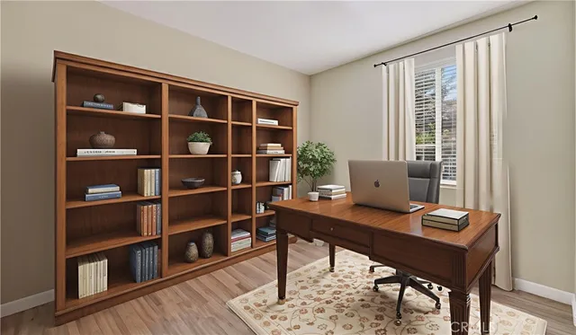 a view of a workspace with furniture and a bookshelf
