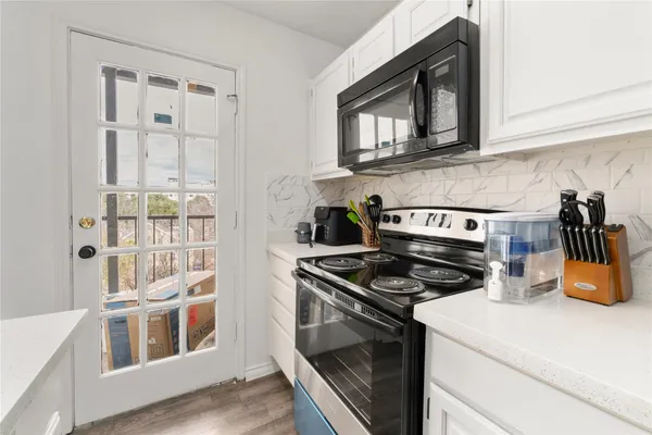 a kitchen with stainless steel appliances granite countertop a stove and a microwave