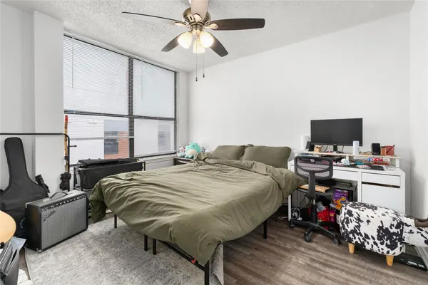 a bed sitting in a bedroom next to a window