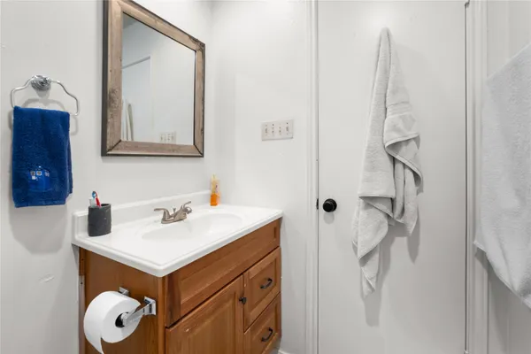 a bathroom with a sink a toilet and a mirror
