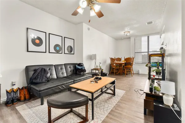a living room with furniture and wooden floor