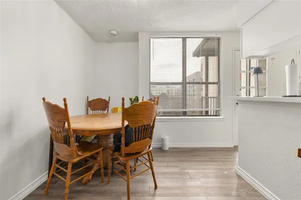 a view of a dining room with furniture and windows