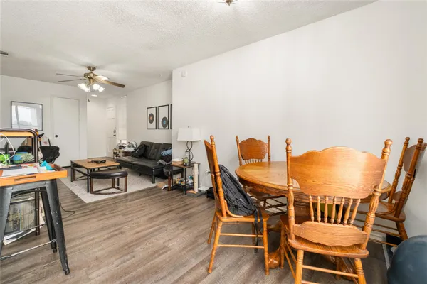 a living room with furniture a fireplace and a chandelier