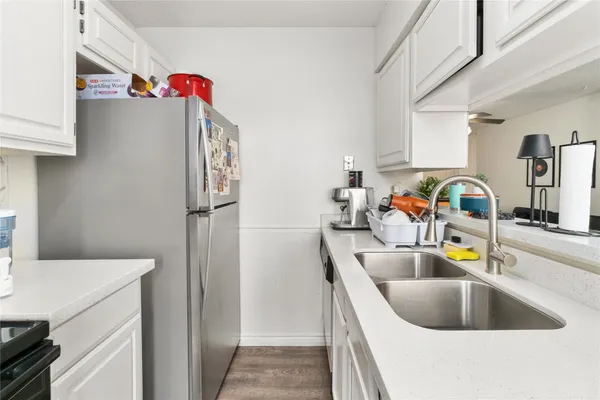 a kitchen with a sink and a refrigerator
