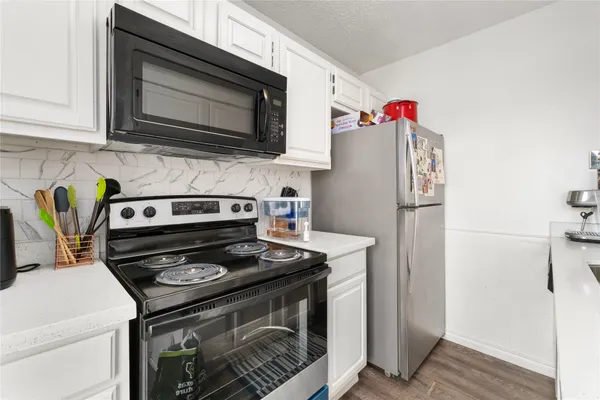a kitchen with a stove and a microwave