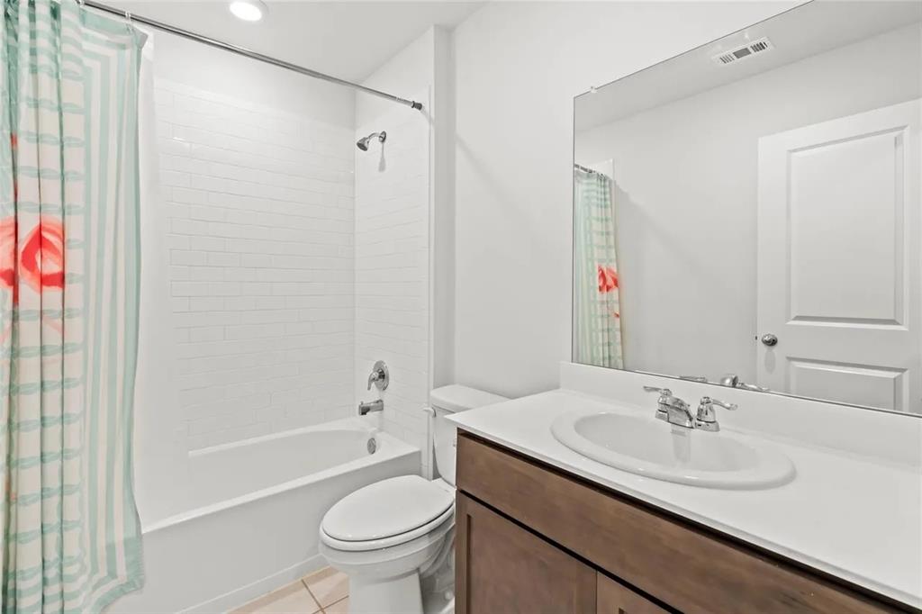 171 Seabiscuit Road Caddo Mills, TX 75135 - Photo 14 of 19 a bathroom with a granite countertop sink a toilet and shower