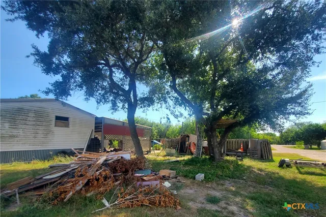 a view of backyard with plants and outdoor seating