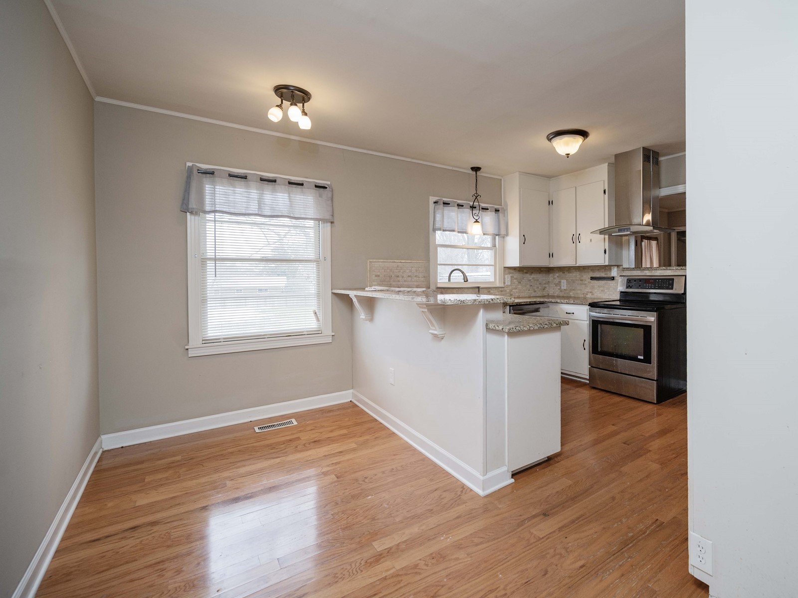 1611 White Boulevard Murfreesboro, TN 37129 - Photo 12 of 30 a kitchen with stainless steel appliances granite countertop a wooden floors and white cabinets