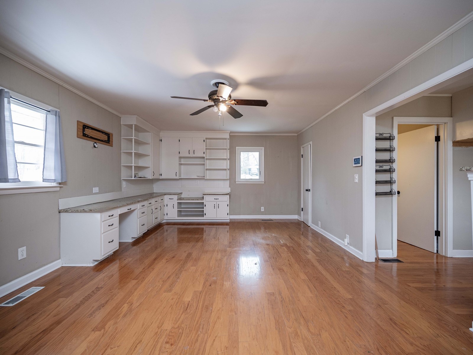 1611 White Boulevard Murfreesboro, TN 37129 - Photo 17 of 30 wooden floor in an empty room with a kitchen