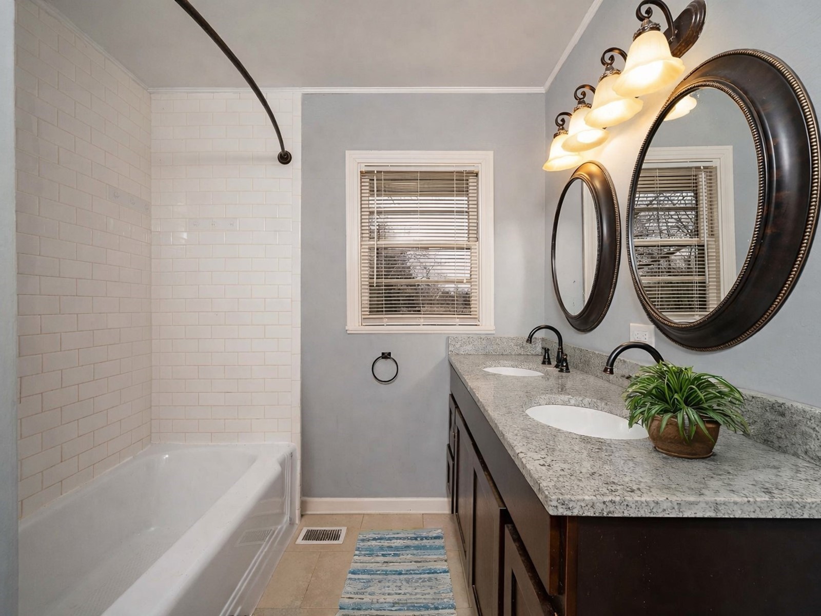 1611 White Boulevard Murfreesboro, TN 37129 - Photo 20 of 30 a bathroom with a granite countertop sink a mirror and a bathtub