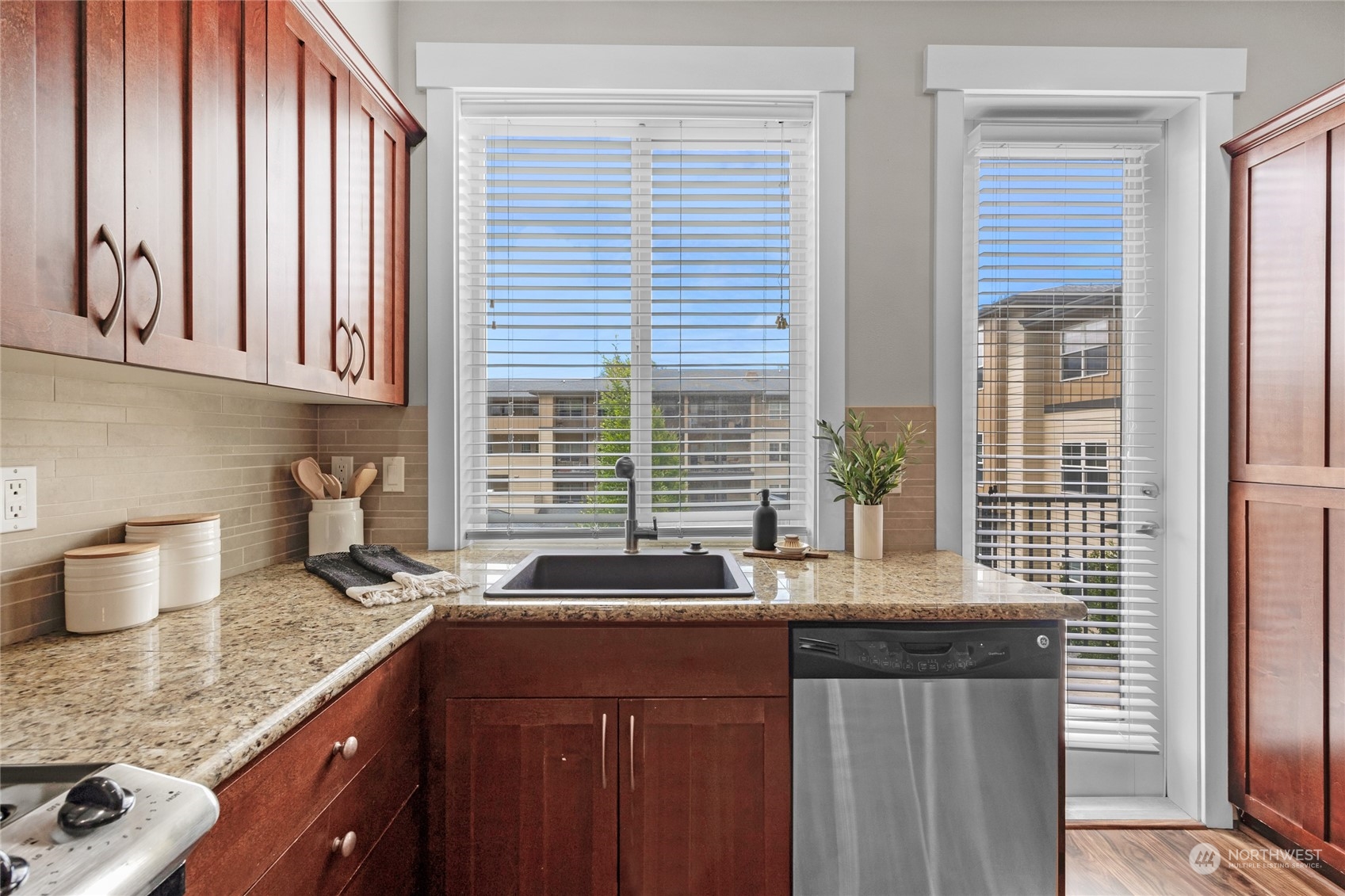 2115 201st Place Southeast, Unit D2 Bothell, WA 98012 - Photo 15 of 31 a kitchen with granite countertop a sink and a window