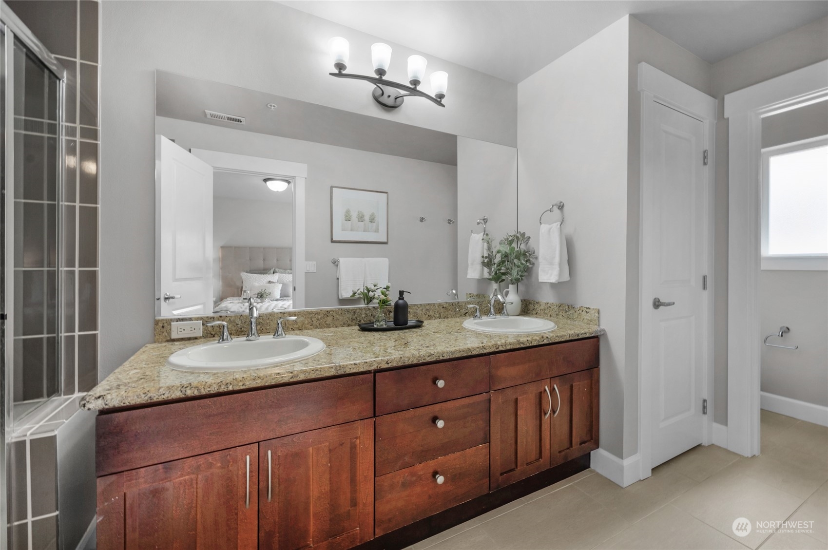 2115 201st Place Southeast, Unit D2 Bothell, WA 98012 - Photo 25 of 31 a bathroom with a granite countertop double vanity sink and a mirror