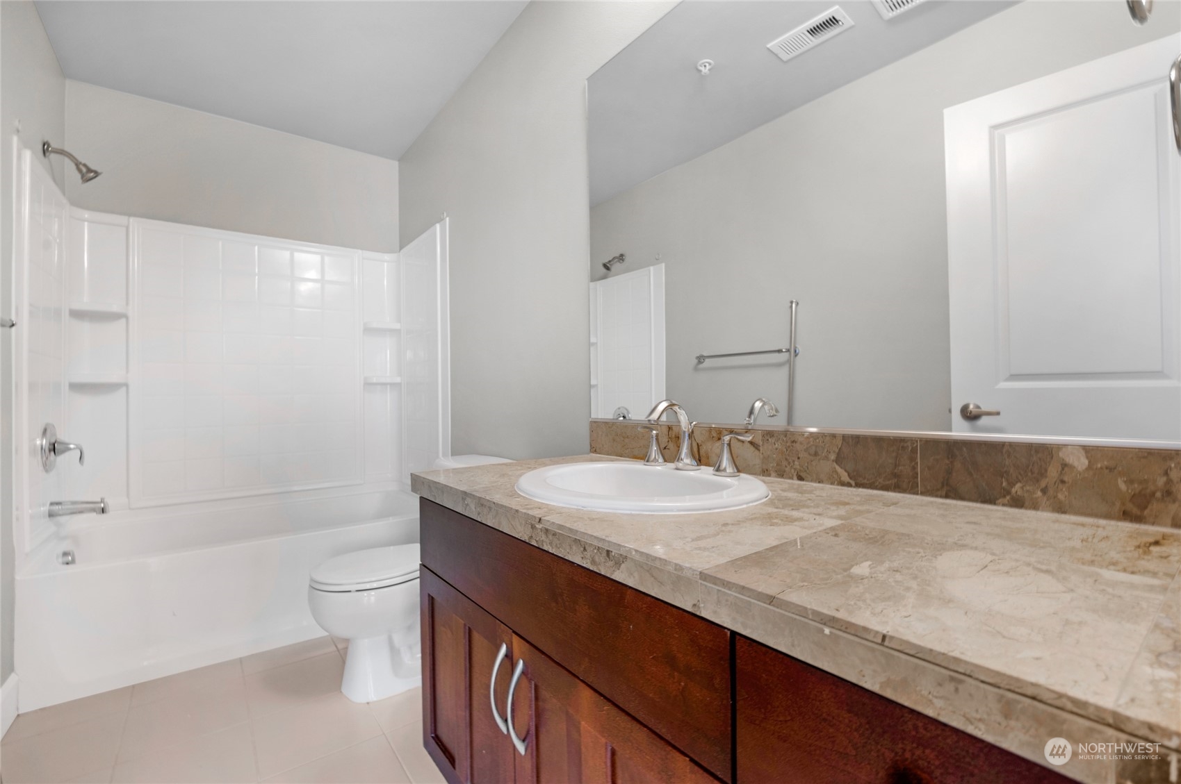 2115 201st Place Southeast, Unit D2 Bothell, WA 98012 - Photo 27 of 31 a bathroom with a granite countertop sink a toilet and shower