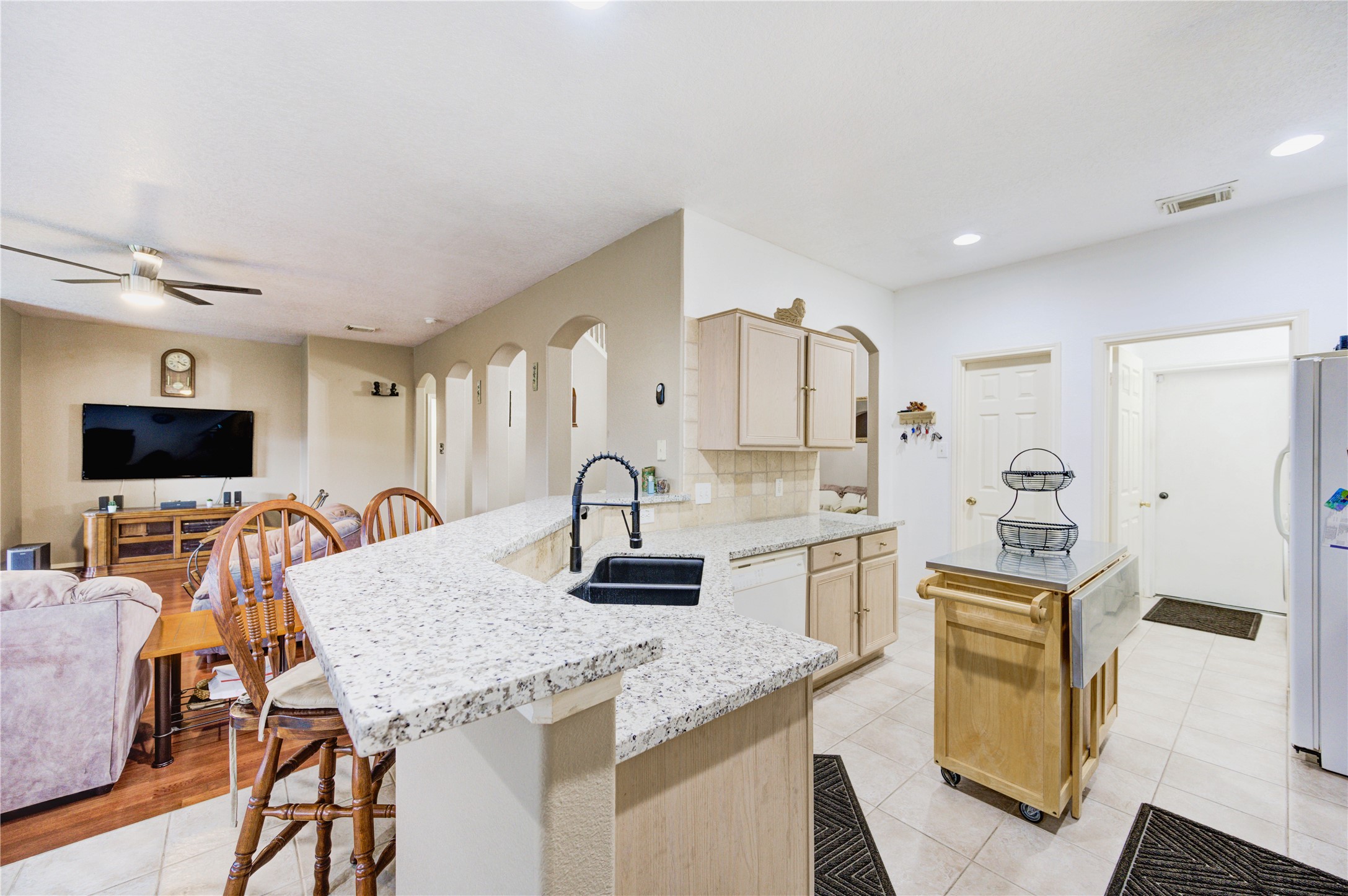 16730 Spring Barker Drive Cypress, TX 77429 - Photo 29 of 50 a kitchen with stainless steel appliances granite countertop a stove a sink and a refrigerator