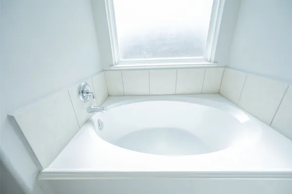 a white bath tub sitting in a bathroom