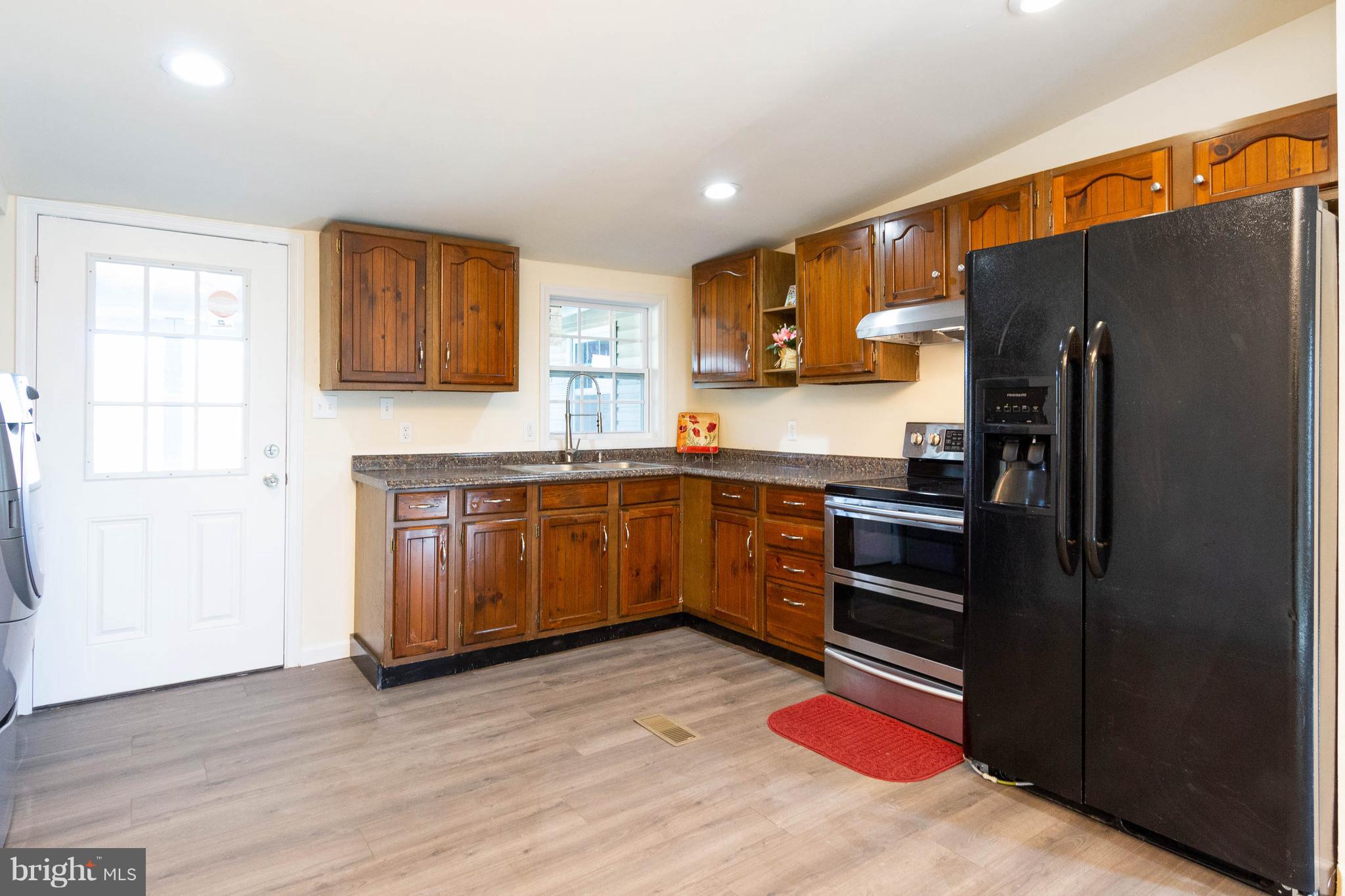 3141 Partlow Road Partlow, VA 22534 - Photo 13 of 25 a kitchen with granite countertop stainless steel appliances and wooden cabinets