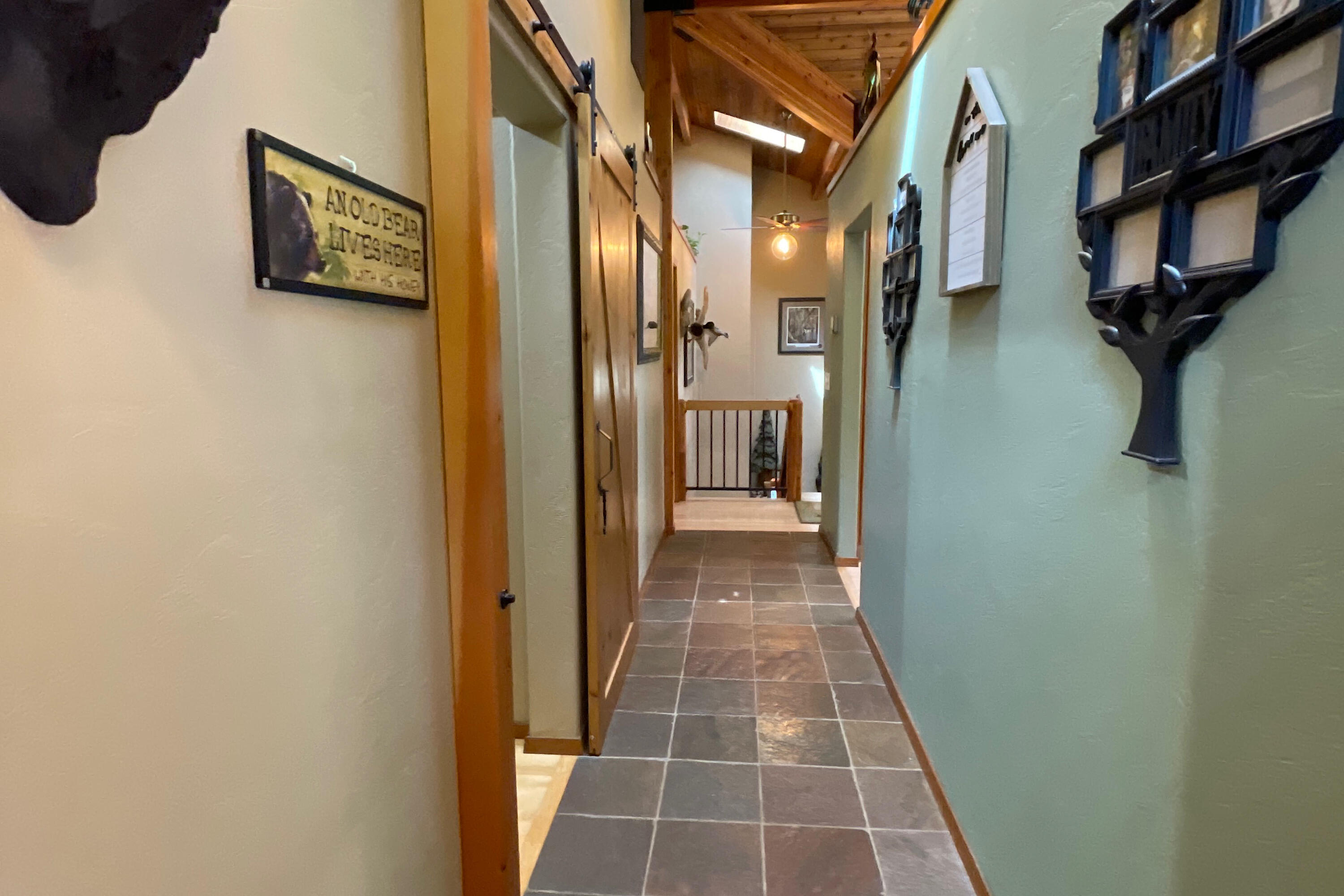 856 Greentree Loop Grants Pass, OR 97527 - Photo 32 of 62 a view of a hallway with paintings on the wall