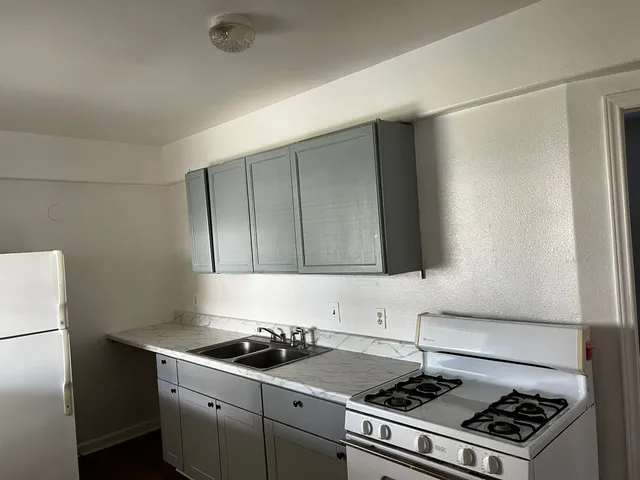 a kitchen with a stove and a refrigerator
