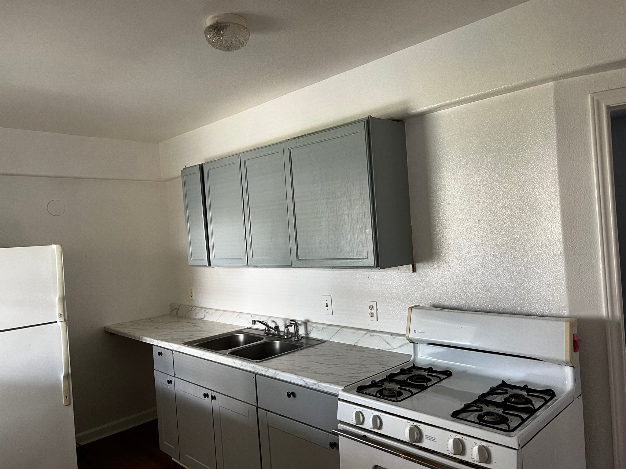 4817 12th Street, Unit A Bacliff, TX 77518 - Photo 5 of 6 a kitchen with a stove and a refrigerator