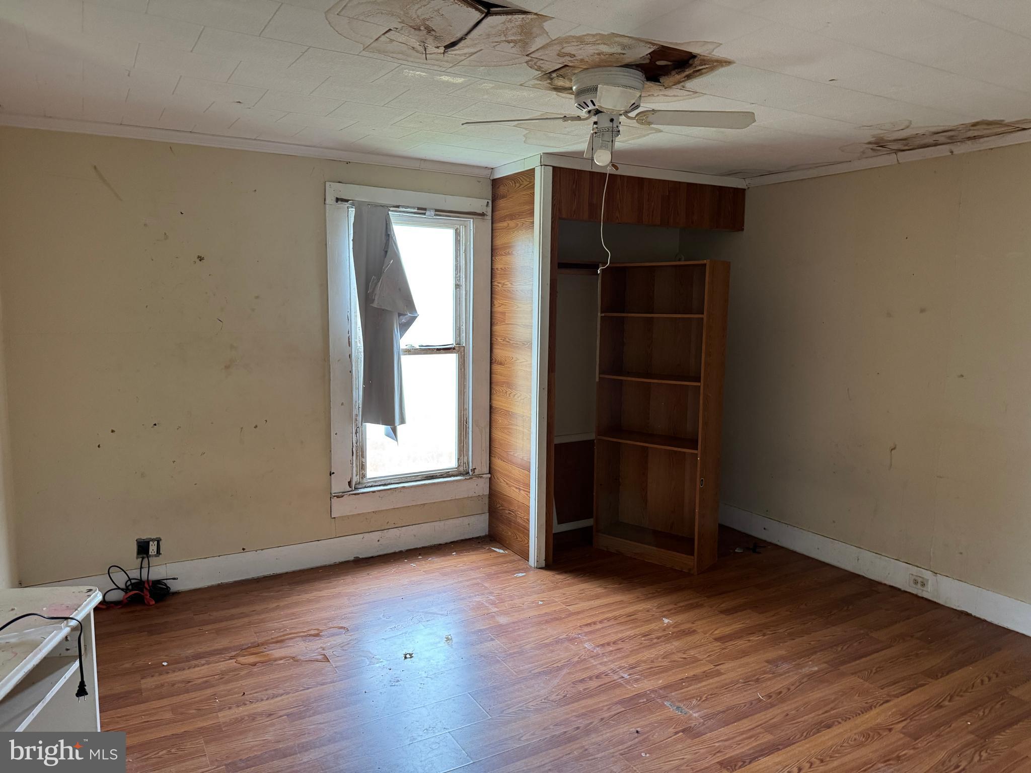 7382 Bullbegger Road Oak Hall, VA 23416 - Photo 16 of 18 an empty room with wooden floor and cabinet