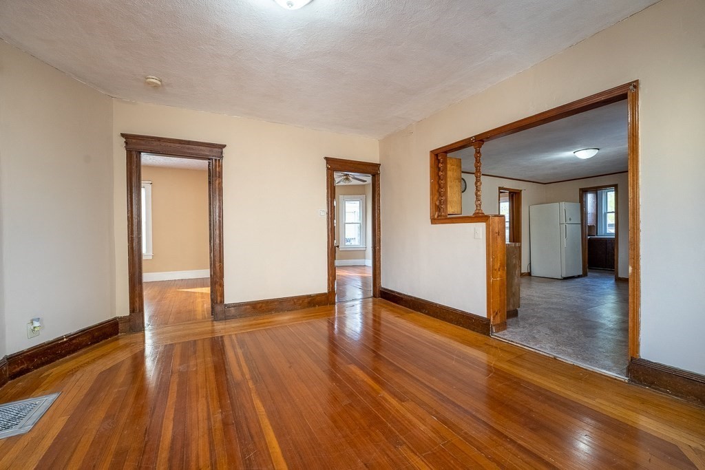 215 White Street Springfield, MA 01108 - Photo 11 of 33 a view of a big room with wooden floor and windows