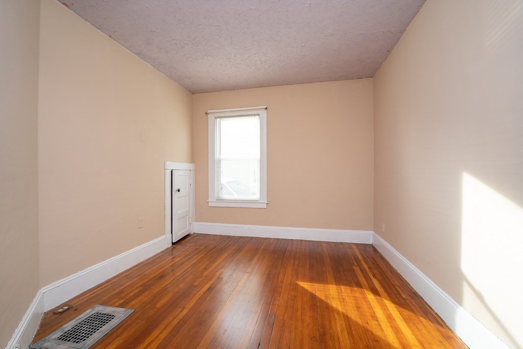 215 White Street Springfield, MA 01108 - Photo 15 of 33 an empty room with wooden floor and windows