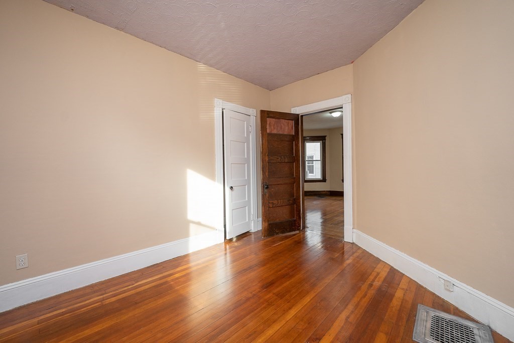 215 White Street Springfield, MA 01108 - Photo 16 of 33 a view of an empty room with wooden floor and a window