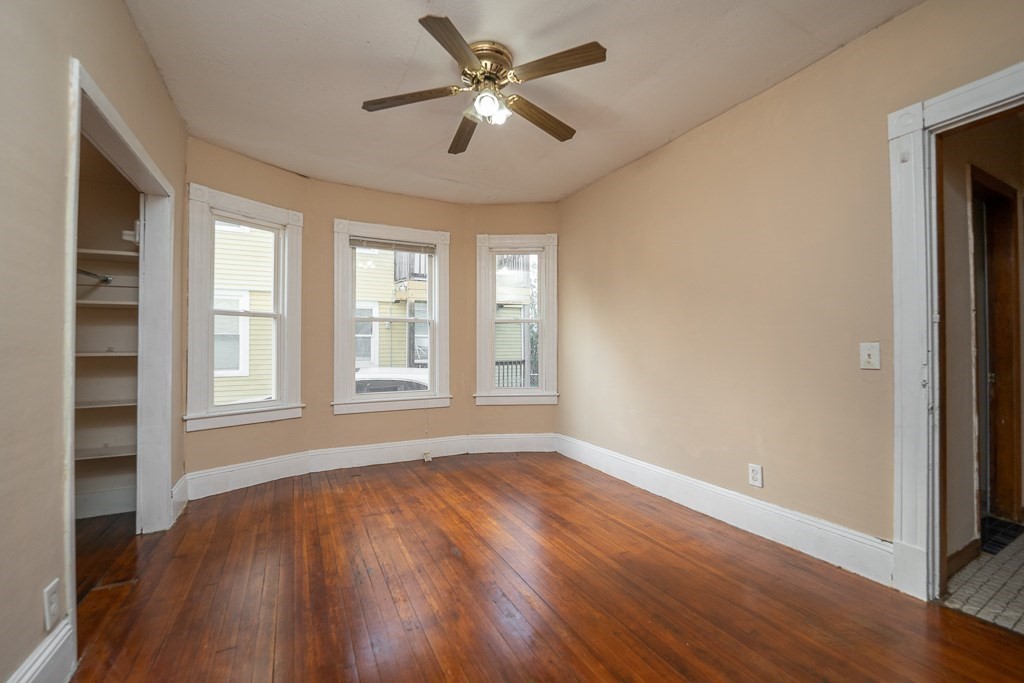 215 White Street Springfield, MA 01108 - Photo 18 of 33 a view of an empty room with a window and wooden floor