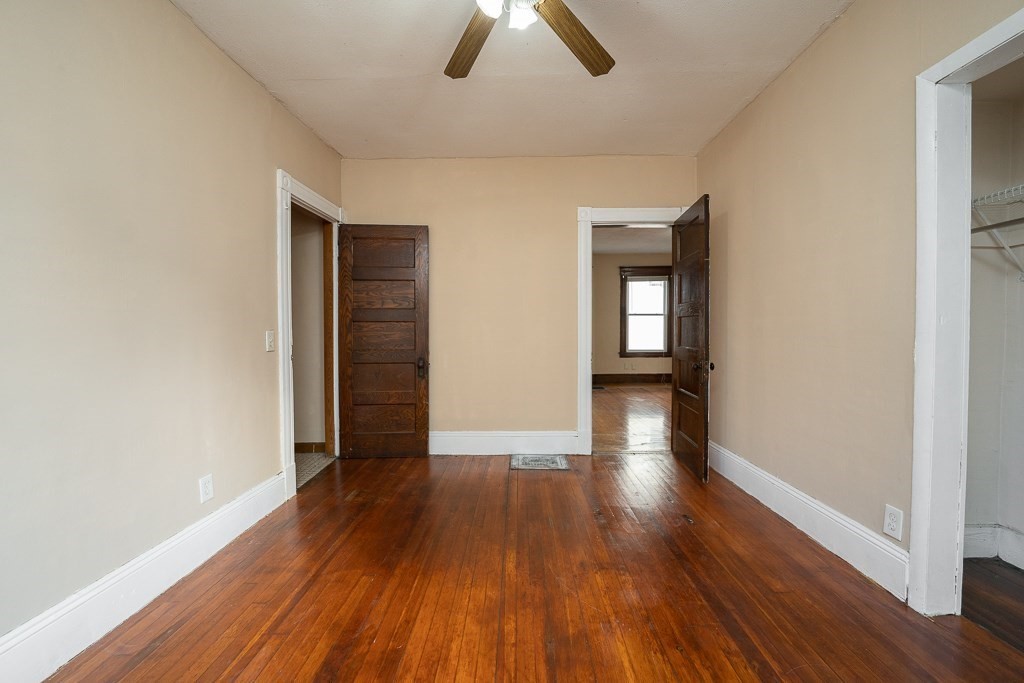 215 White Street Springfield, MA 01108 - Photo 19 of 33 an empty room with closet and wooden floor