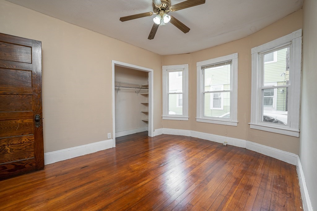 215 White Street Springfield, MA 01108 - Photo 20 of 33 an empty room with wooden floor closet and windows