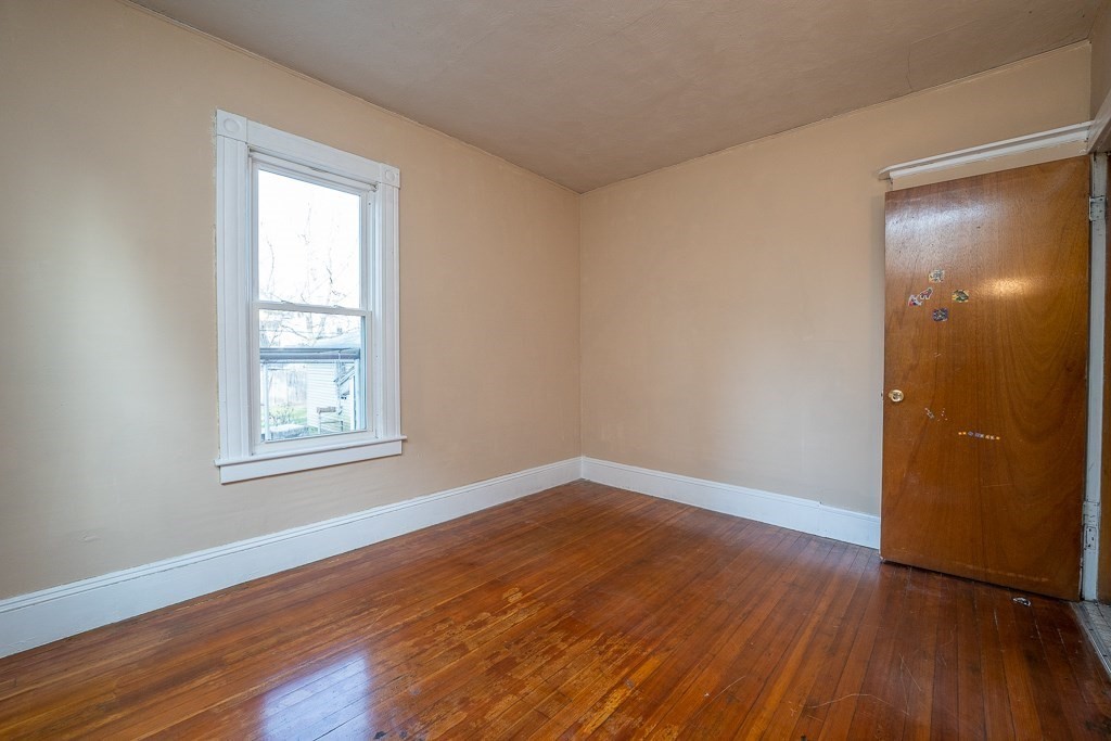 215 White Street Springfield, MA 01108 - Photo 22 of 33 an empty room with wooden floor and windows