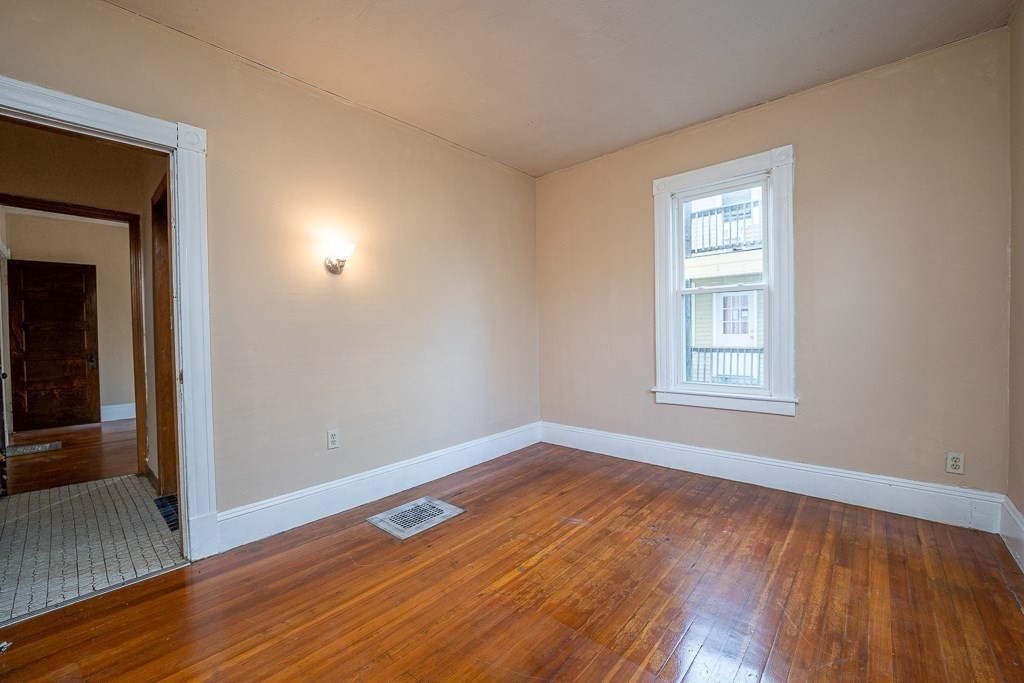 215 White Street Springfield, MA 01108 - Photo 24 of 33 an empty room with wooden floor and windows