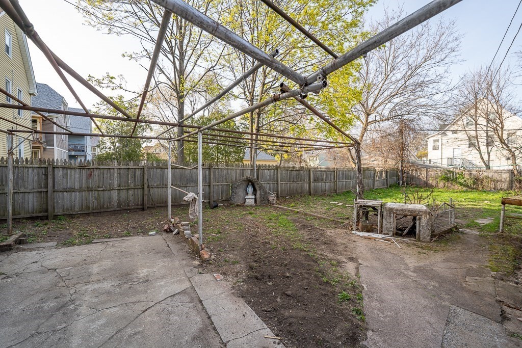 215 White Street Springfield, MA 01108 - Photo 28 of 33 a backyard of a house with barbeque oven and wooden fence