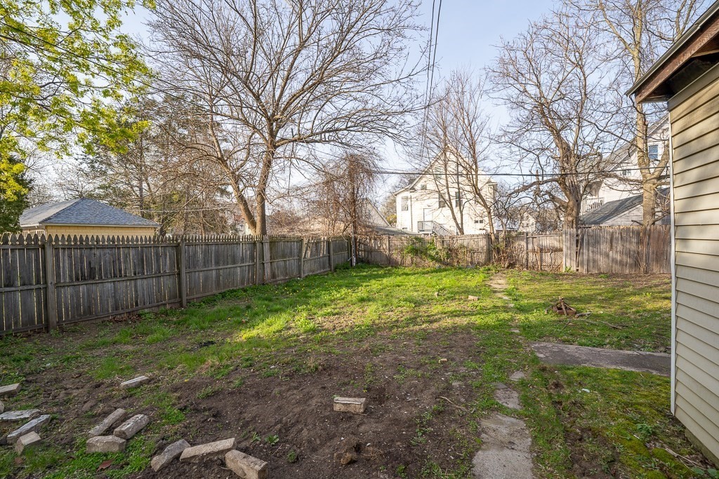 215 White Street Springfield, MA 01108 - Photo 29 of 33 a view of a backyard with large trees and wooden fence