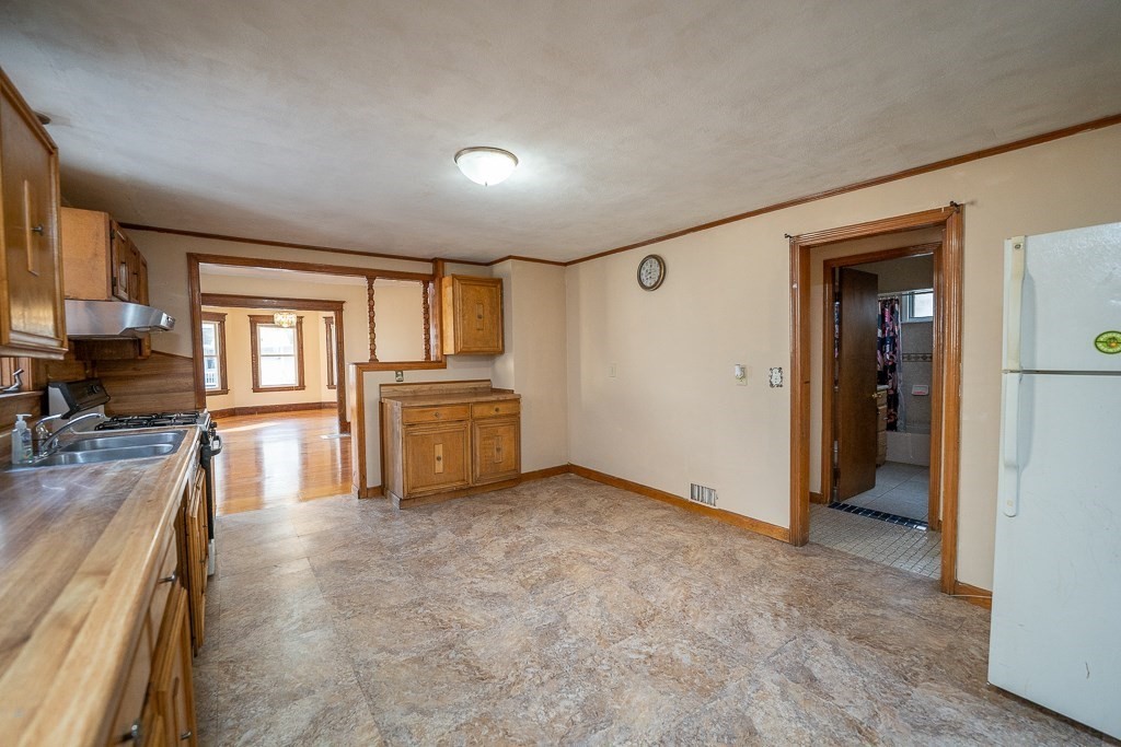 215 White Street Springfield, MA 01108 - Photo 3 of 33 a view of a kitchen with a sink cabinets and a large window
